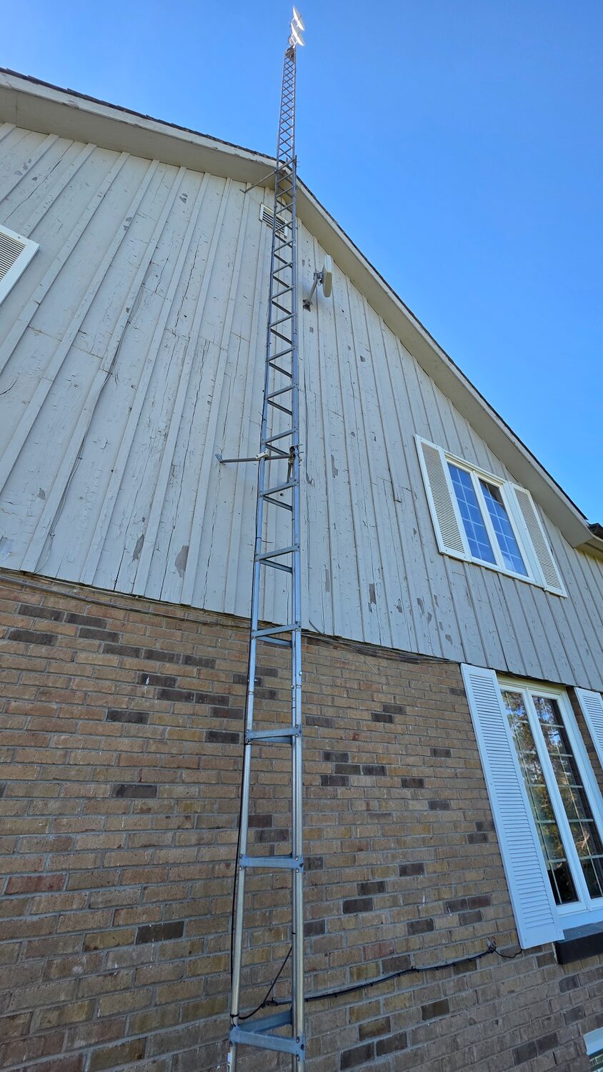 Old residential tower still attached to the side of a house.
